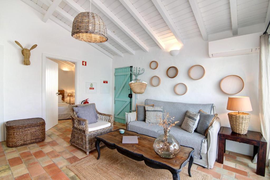 a living room with a couch and a table at Casa de Benafim 1 in Benafim