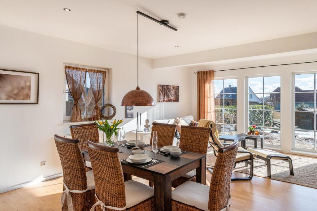 a dining room and living room with a table and chairs at Casa Meeresbrise Marlow in Marlow