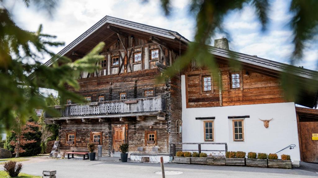 an old log house with a porch at Apartment Kracherlemoos in Seefeld in Tirol