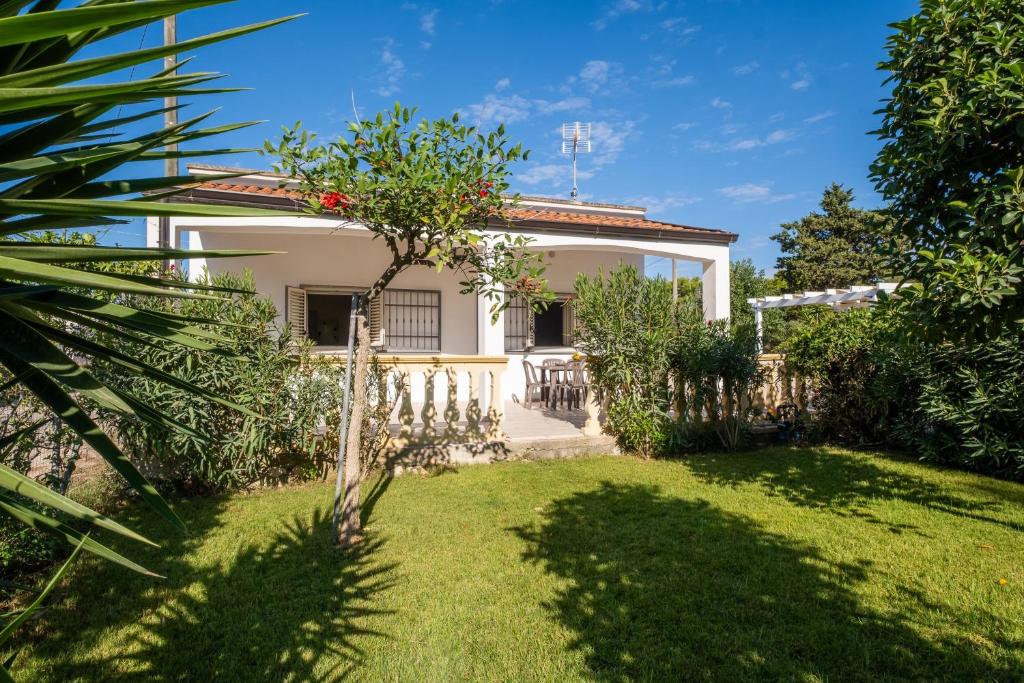 a view of a house with a yard at Villa Aurea Retreat Lux in Porto Cesareo