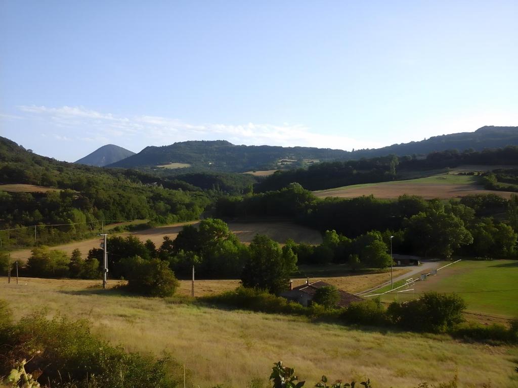 a view of a field with mountains in the background at Gîte À La Campagne in Bourdeaux