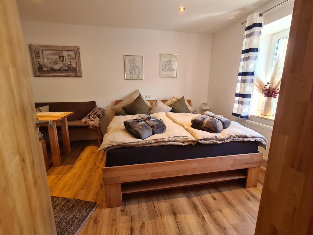 a bedroom with a bed with pillows on it at Rosenzauber Kraxler Pärchen in Weißenstadt