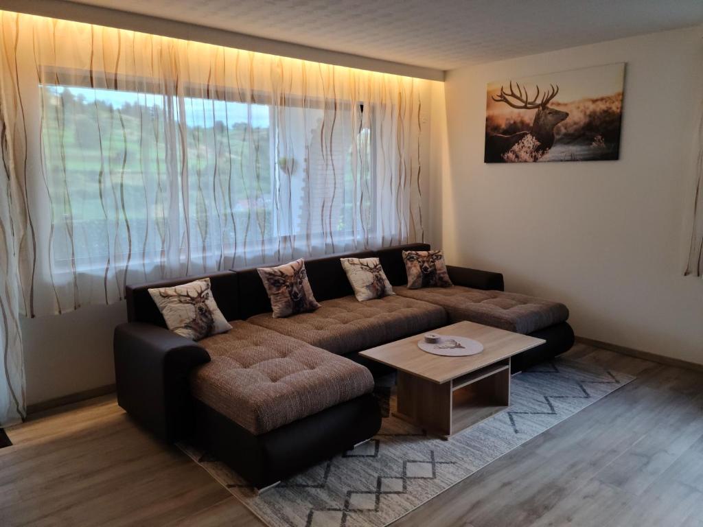 a living room with a couch and a table at Ferienwohnung am Südhang in Gernsbach