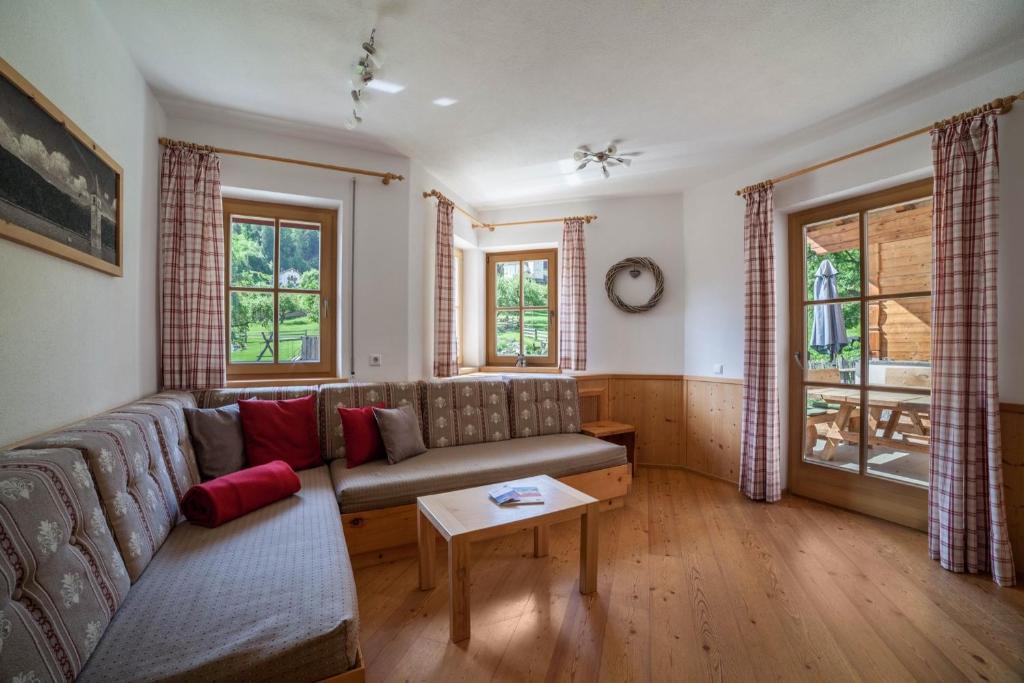 a living room with a couch and a table at Ferienhaus Hof am Schloss in Prato allo Stelvio