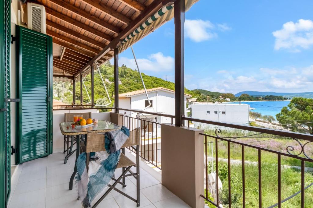 a balcony with a table and a view of the ocean at Nikoleta Apartment 2 in Nikiana