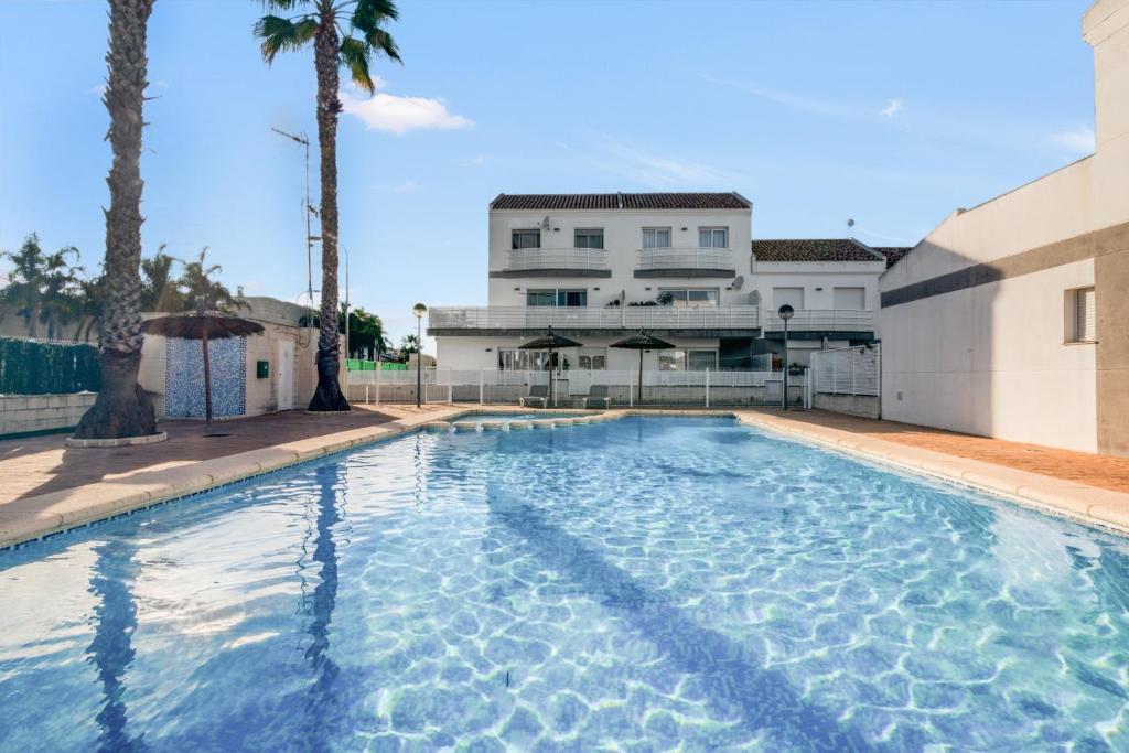a swimming pool in front of a building at Casa Isabel in El Verger