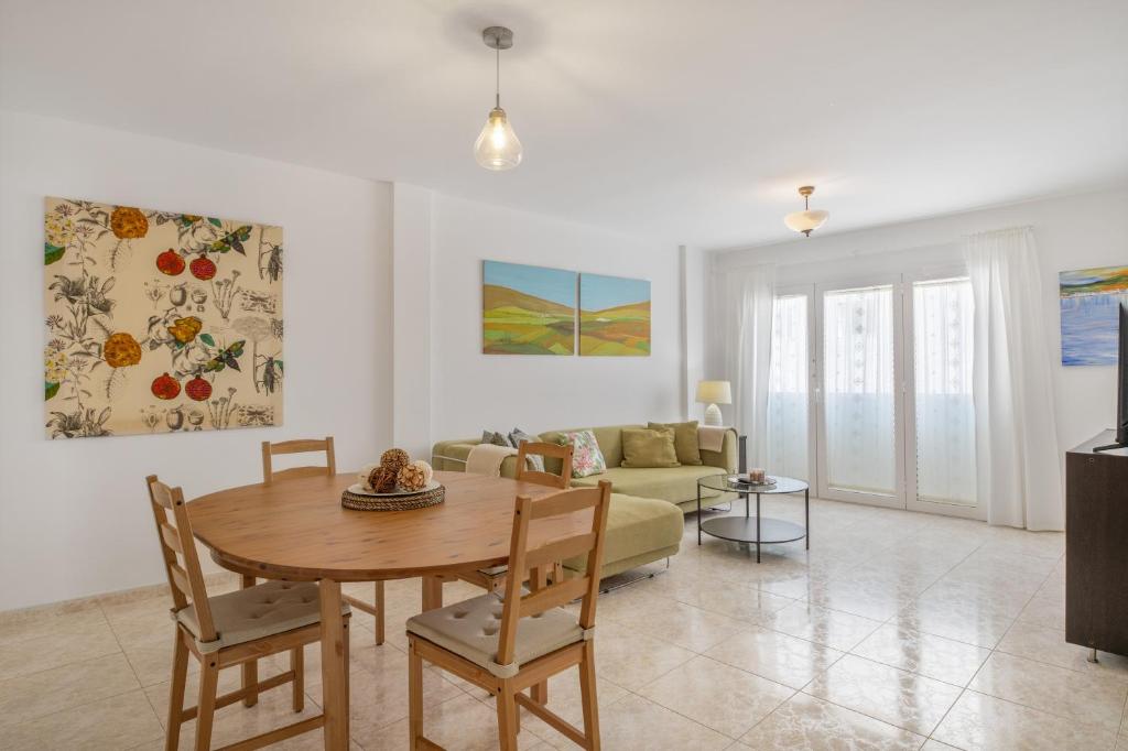 a living room with a table and a couch at Suite Cava in Arrecife