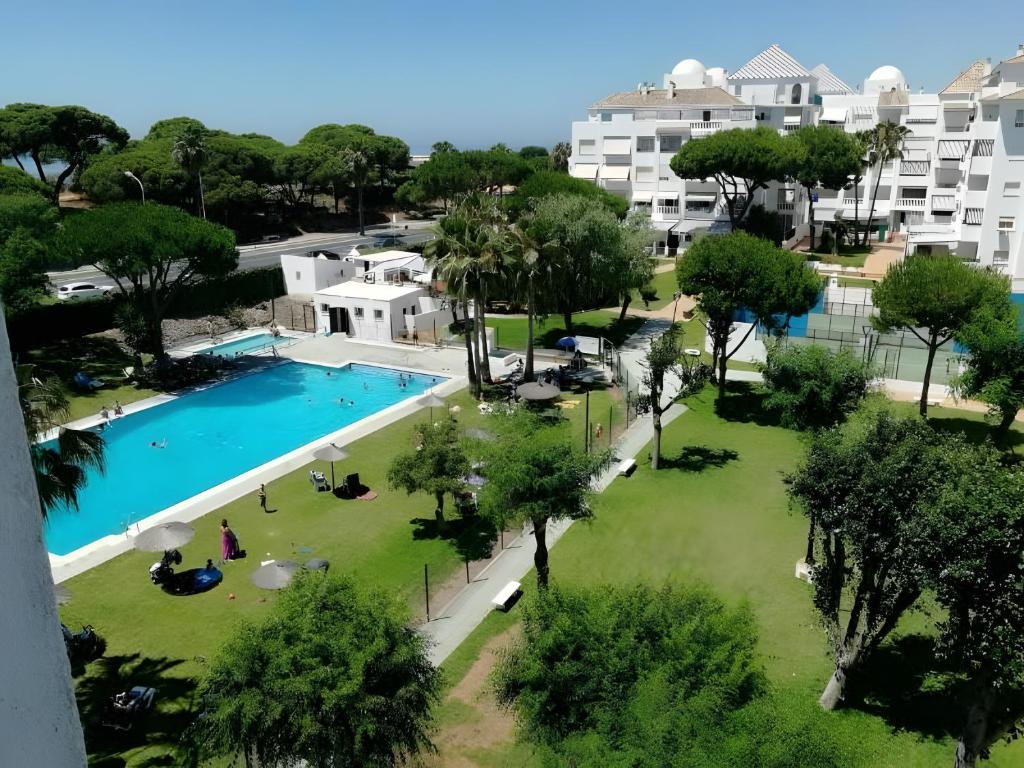 an overhead view of a large swimming pool with trees and buildings at El Portil Pinares in El Portil