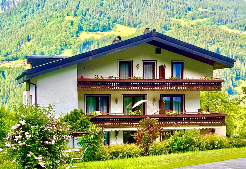 a house with flowers on the balconies on a mountain at Jordis in Vandans