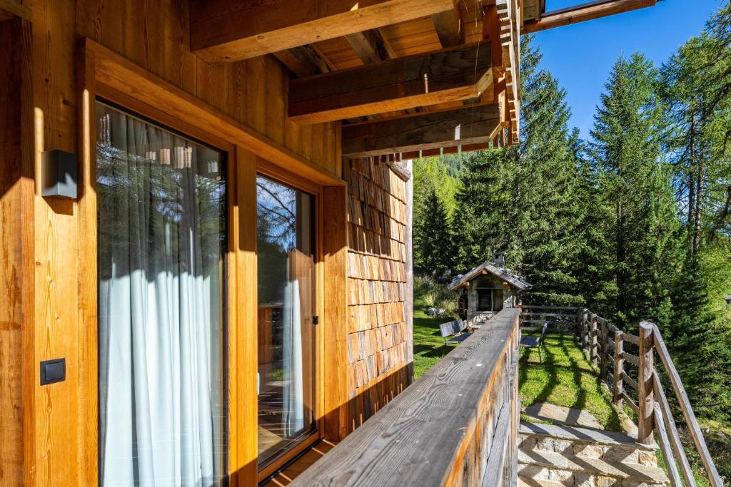 a wooden house with a large window on a deck at Grogg 608 Apt I in Martello