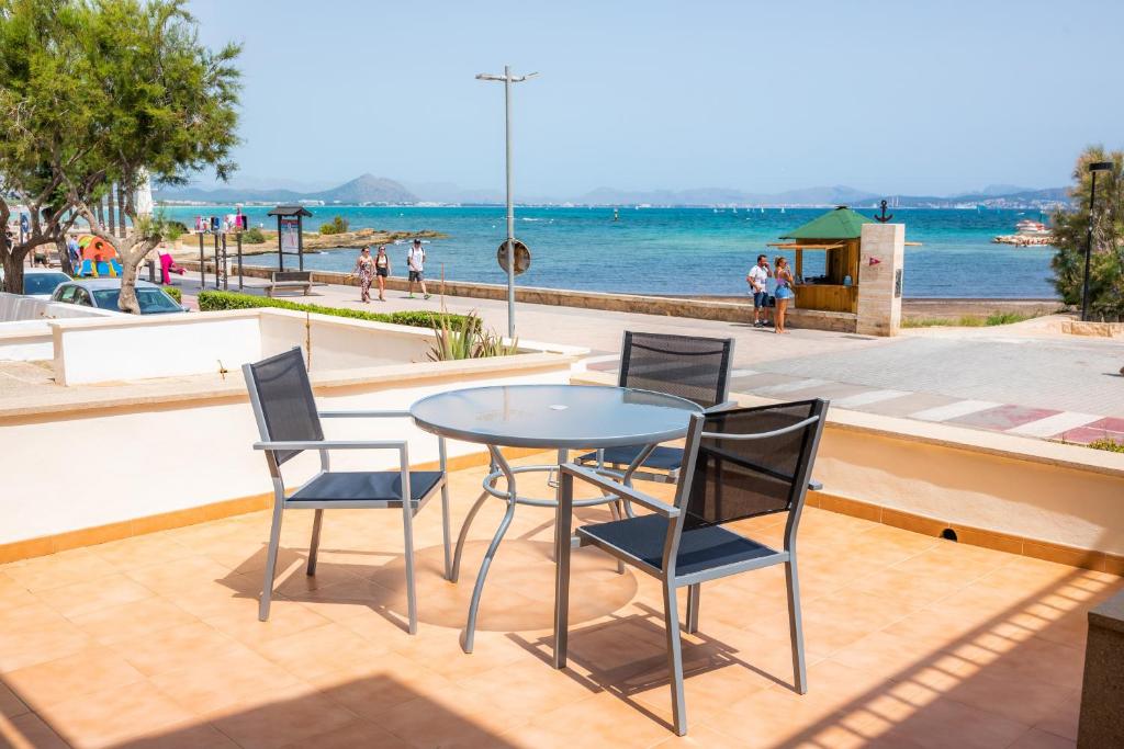 a table and chairs on a patio overlooking the water at Casa Mulet in Can Picafort