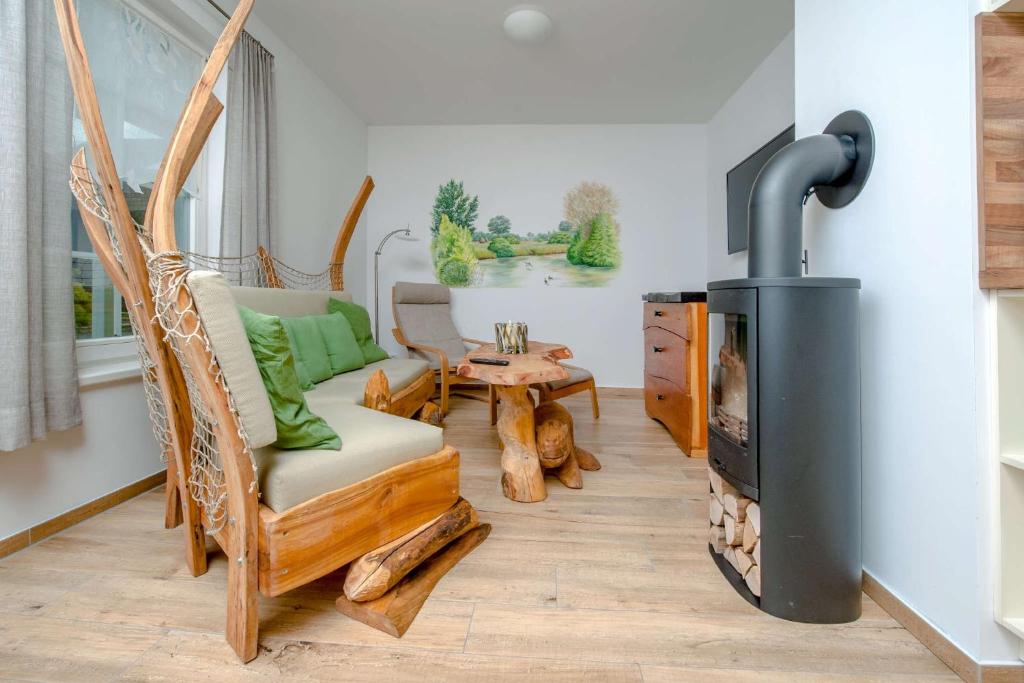 a living room with a wood burning stove at Ferienwohnung Fliess in Neuendorf am See