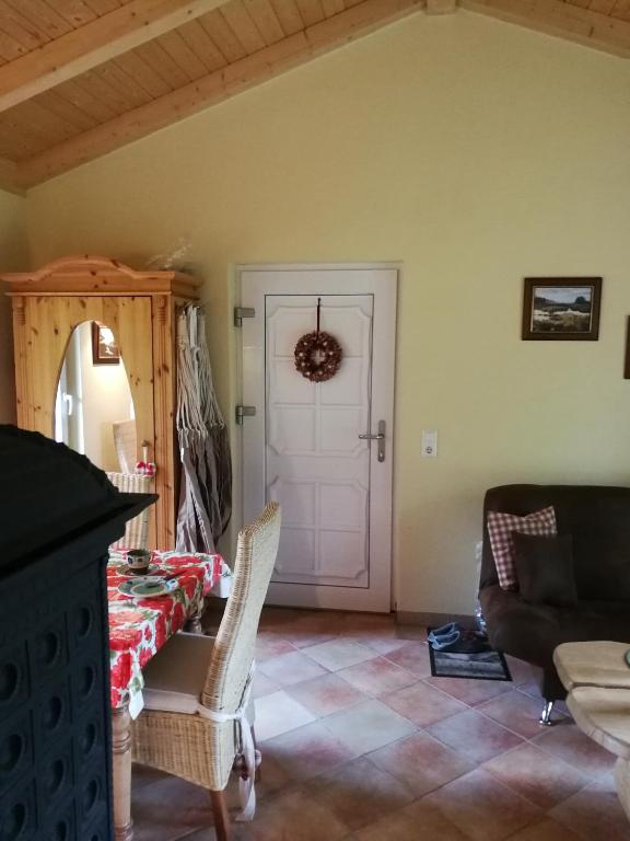 a living room with a table and a white door at Jagdhaus Franz in Krahne