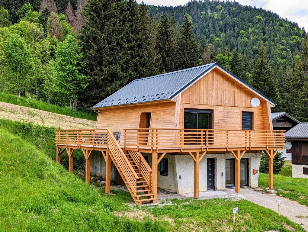a house with a solar roof on top of it at Chalet le Lys Martagon in Saint-Pierre-dʼEntremont
