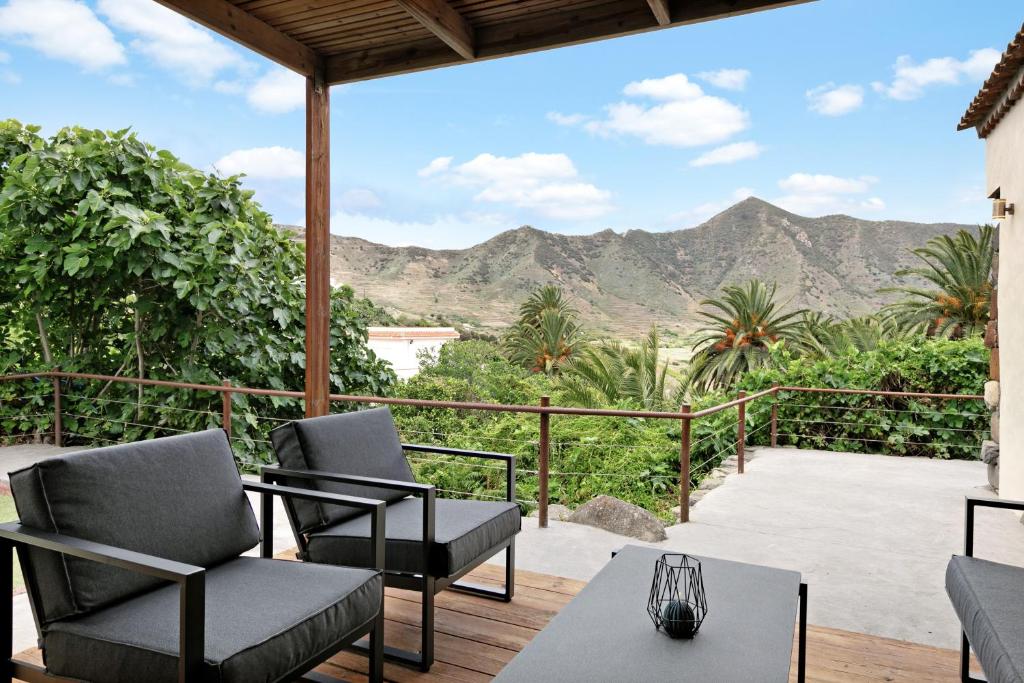 a patio with chairs and a view of the mountains at El Portillo 1 in Buenavista del Norte