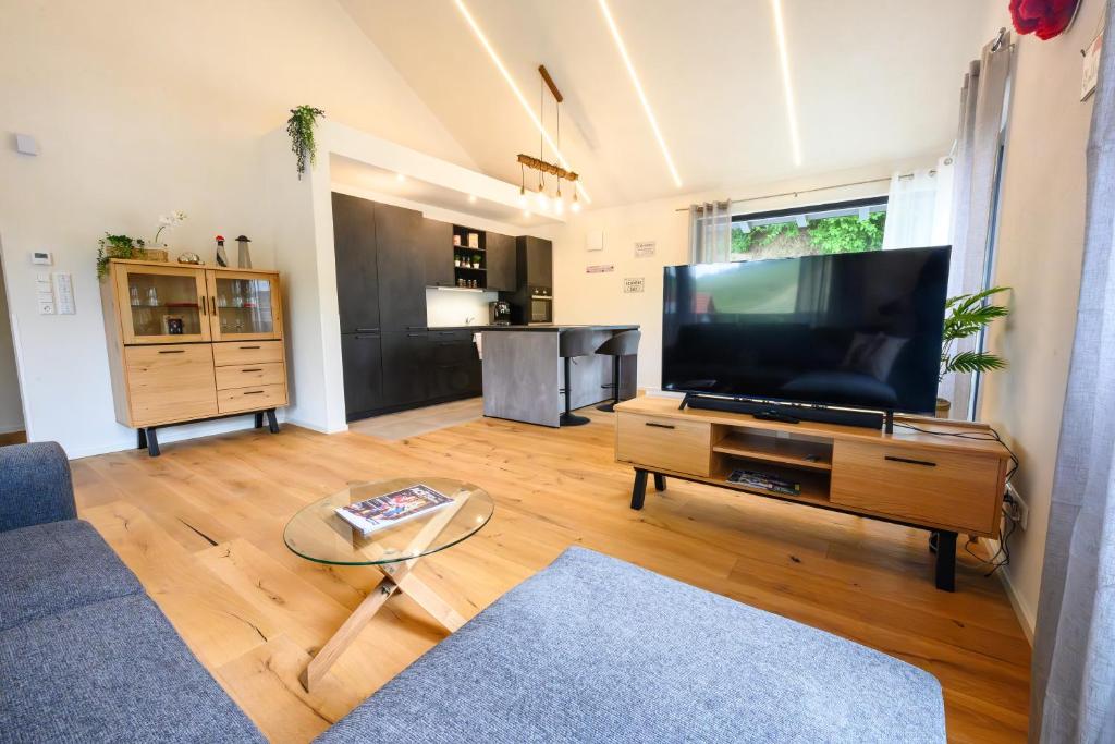 a living room with a large flat screen tv at Ferienwohnung Schwarzwald Penthus in Kappelrodeck