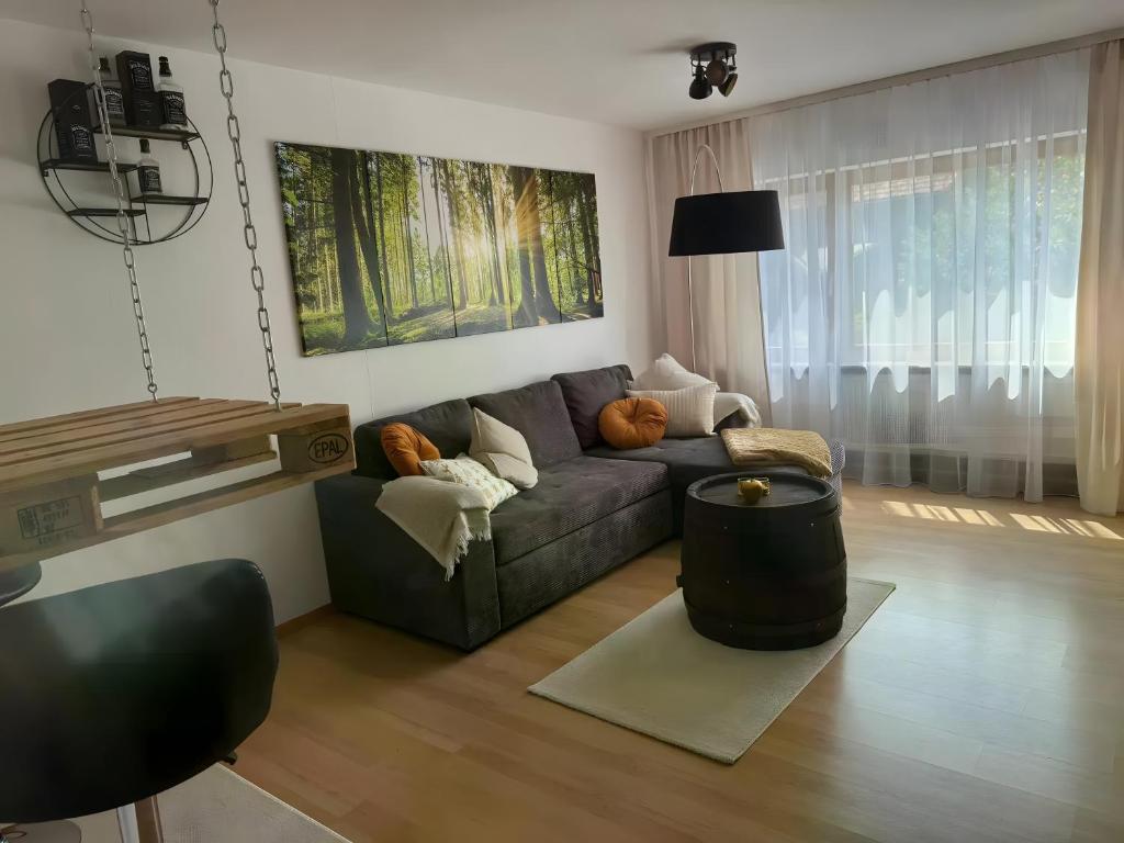 a living room with a couch and a table at Komfort trifft Natur in Albbruck