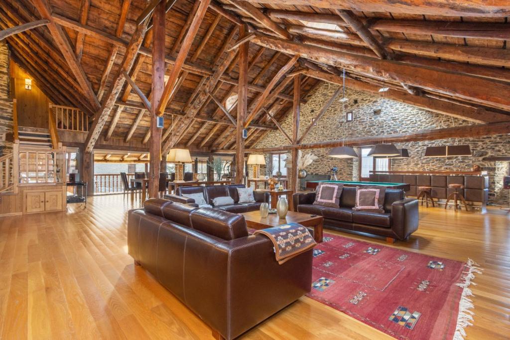 a living room with leather furniture and a pool table at Cobert de Felip in Gavas