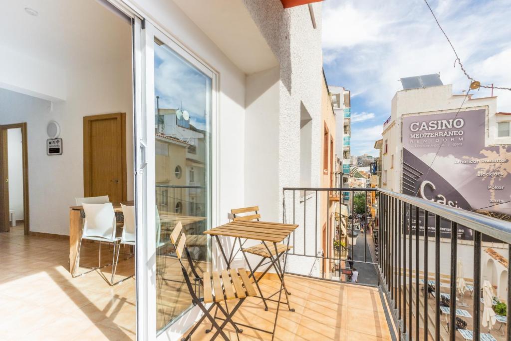 a balcony with a table and chairs on it at Entreplayas Benidorm in Benidorm