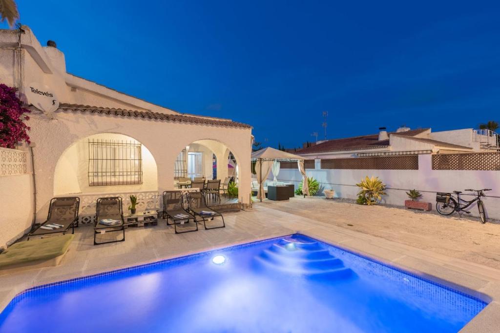 a swimming pool in front of a house at Fidalsa Relax Pool your Refuge in Torrevieja