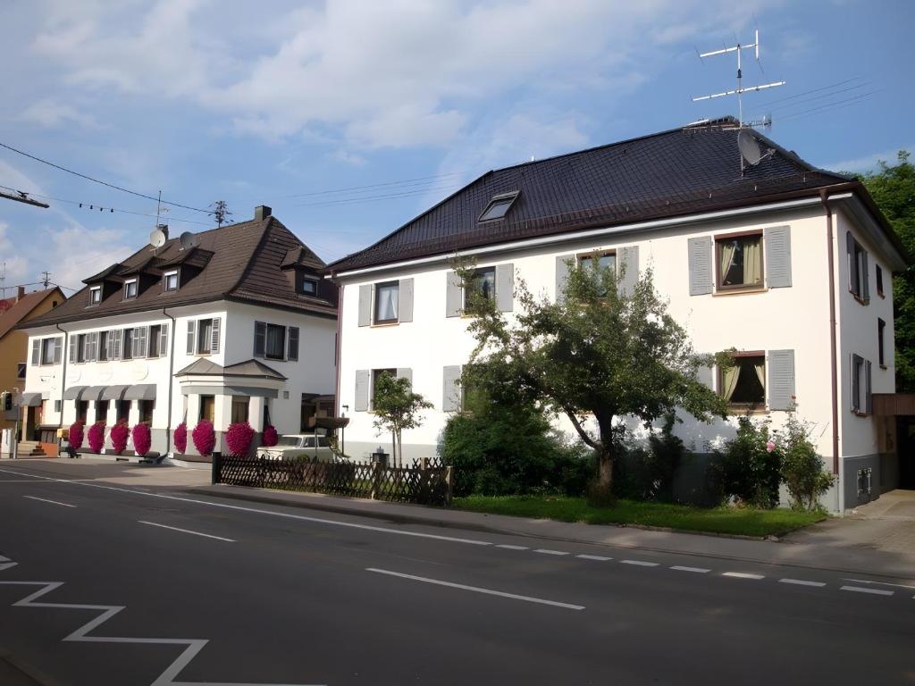 two white houses on the side of a street at Hotel Garni Siedlerstube in Nürtingen