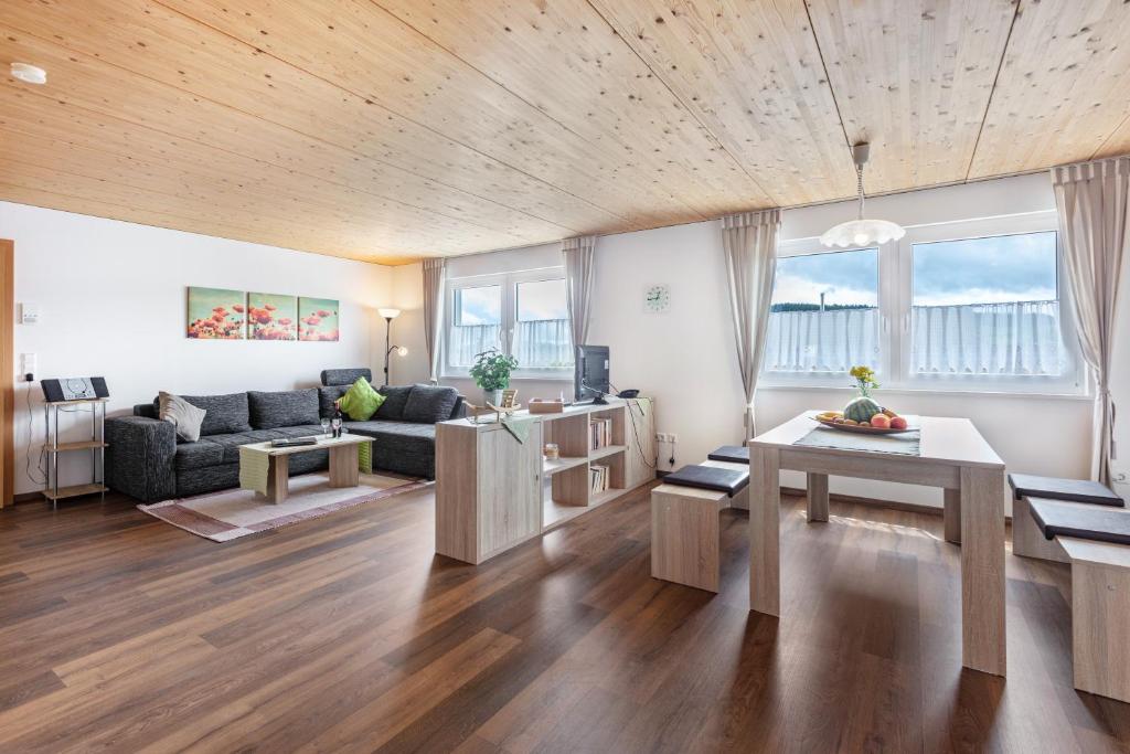 a living room with a couch and a table at Hochtalblick - Fewo Oren in Bernau im Schwarzwald