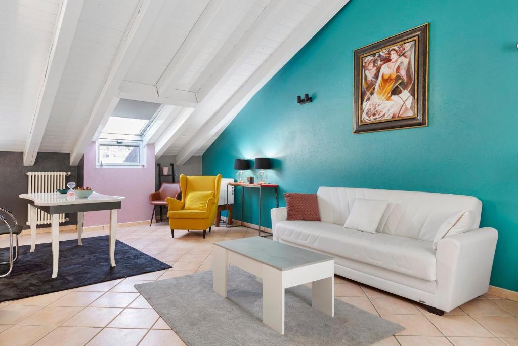 a living room with a couch and a table at Mema Holiday Home in Aosta