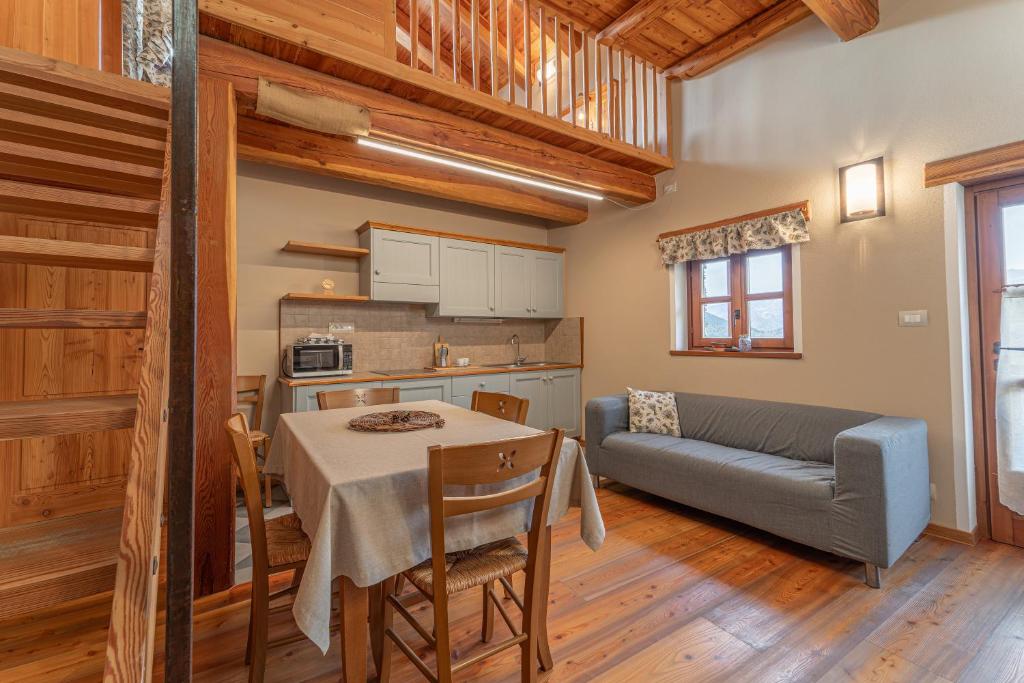 a kitchen and living room with a table and a couch at Civico 13 in Marmora