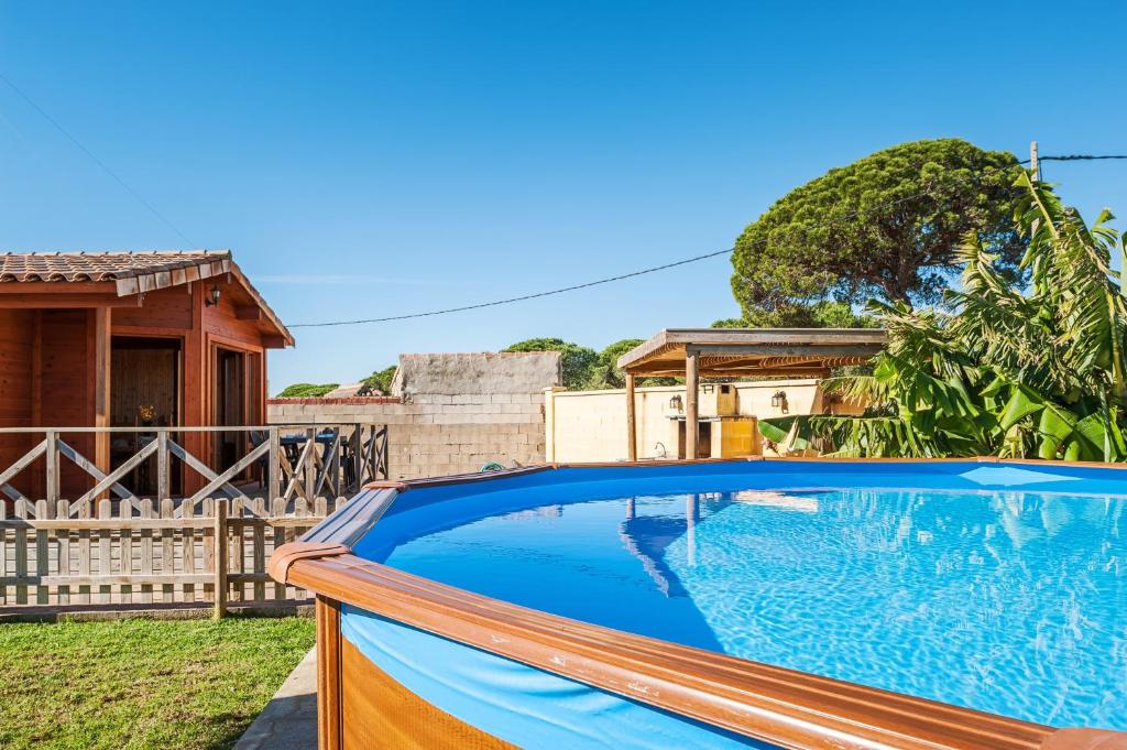 a swimming pool in front of a house at Las tres hermanas in Conil de la Frontera