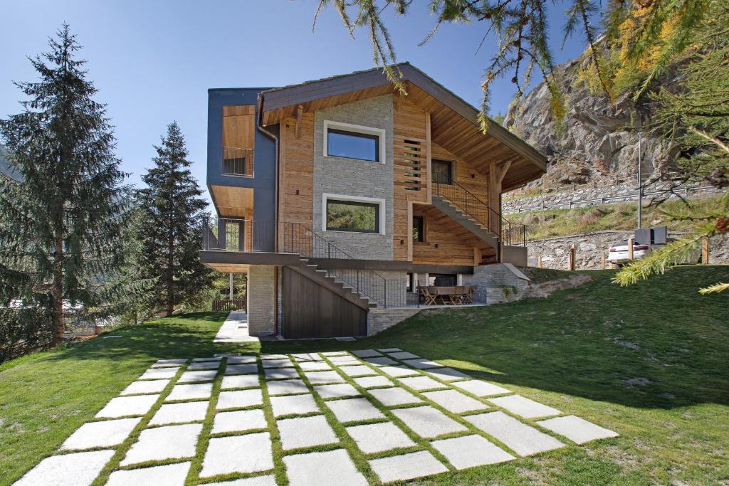 a house on the side of a hill with a pathway at Valgrisa Mountain Lodges 1 in Valgrisenche