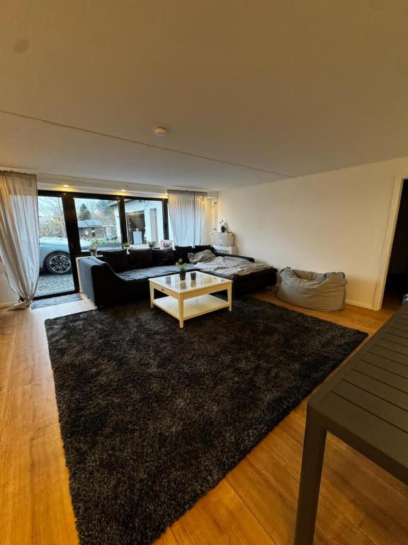 a living room with a couch and a table at Rosenhaus in Merchweiler