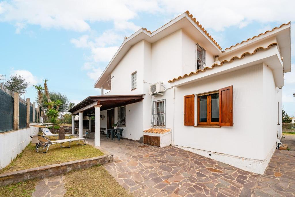 a white house with a patio in front of it at Brezza di Mare in Calasetta