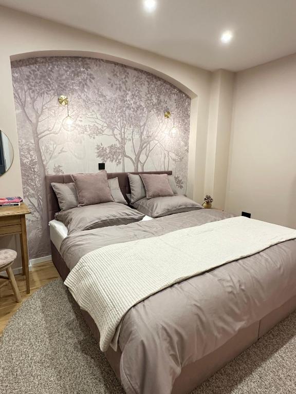 a bedroom with a large bed with a wall at Fewo Sand 10 - Altstadtsuite in Bamberg