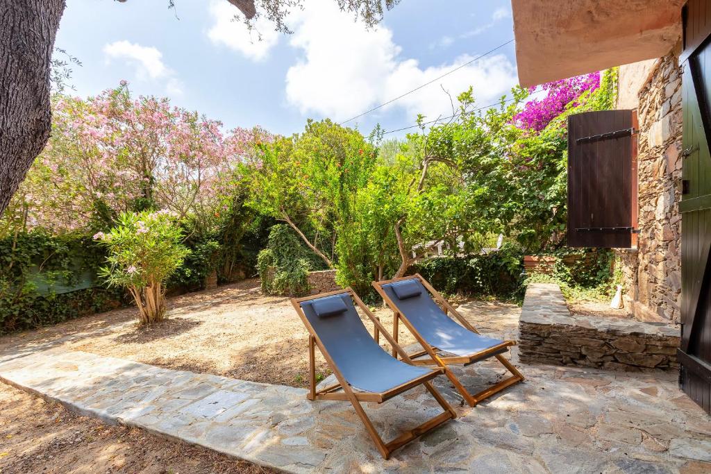 two chairs sitting on the patio of a house at Villa Grecale in Stintino