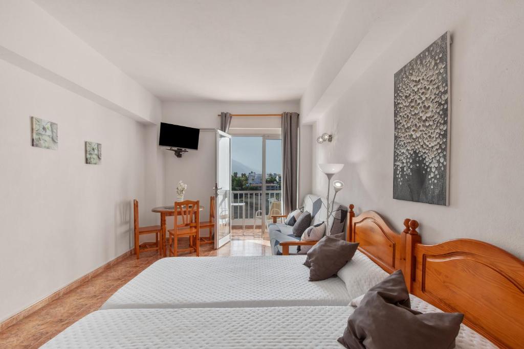 a bedroom with two beds and a living room at Apartamentos Martin - 22 in Puerto Naos