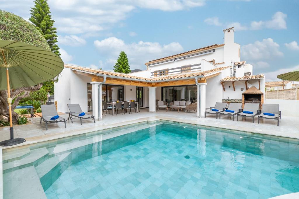 a villa with a swimming pool and a house at Villa Ana Puerto Pollensa in El Port