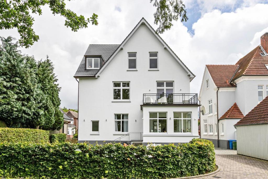 a white house with a black roof at Villa Elysium in Heide