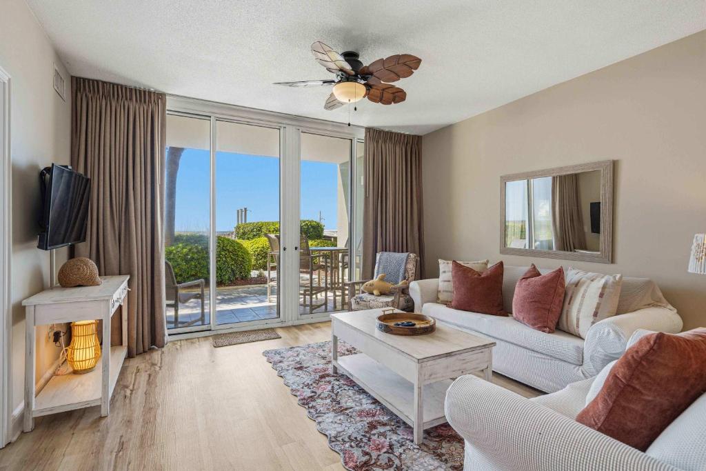 a living room with a couch and a tv at Gulf Front condo with Beach access and shared Pool in Fort Walton Beach