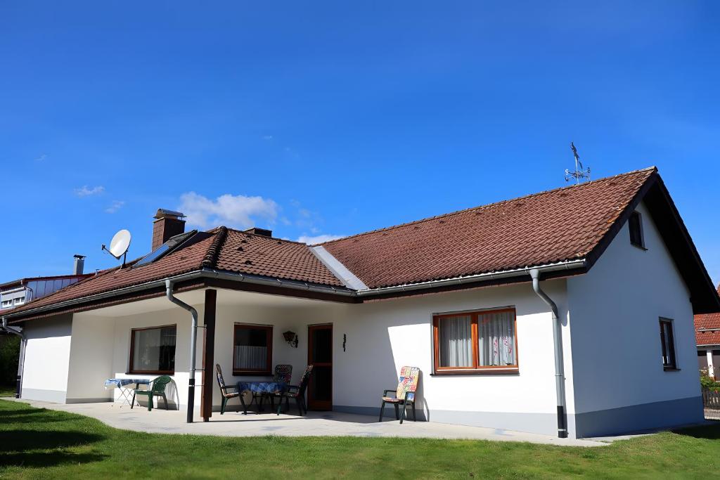 a white house with a brown roof at Haus Titisee in Löffingen