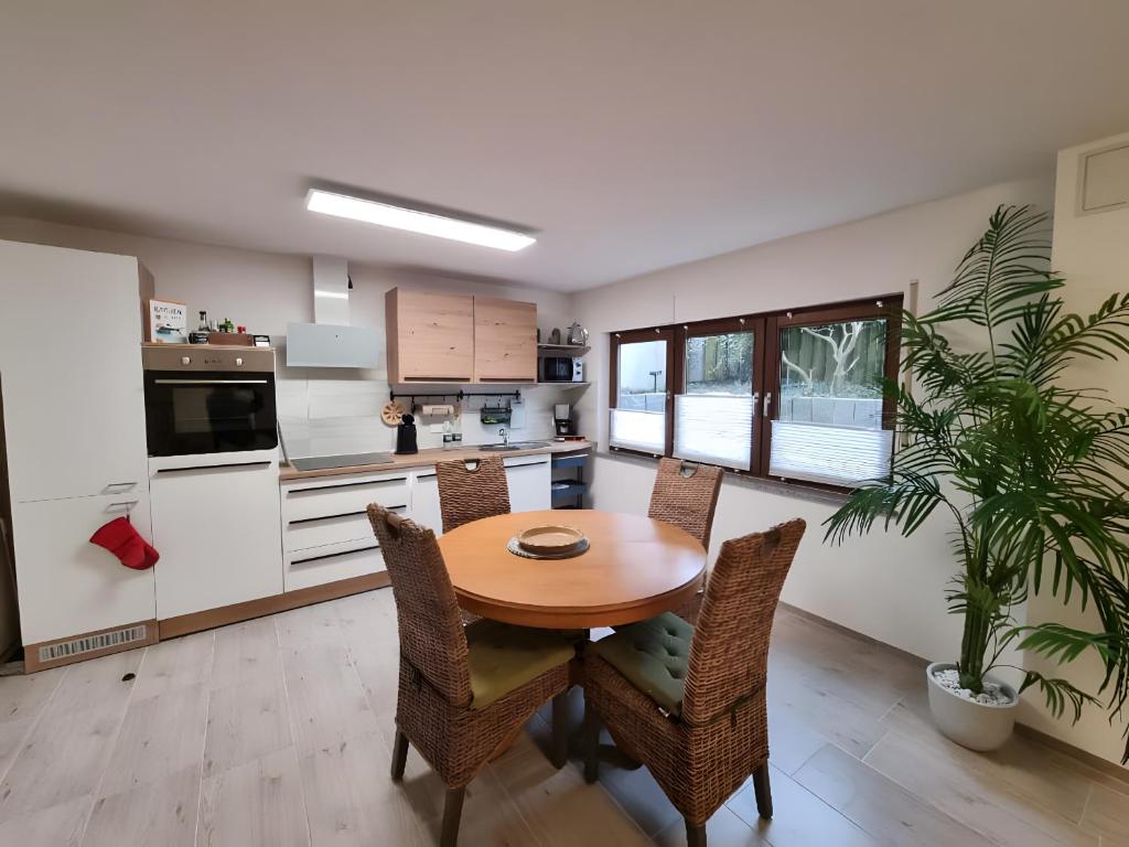 a kitchen and dining room with a wooden table and chairs at Ferienwohnung Rheinnähe in Bad Säckingen