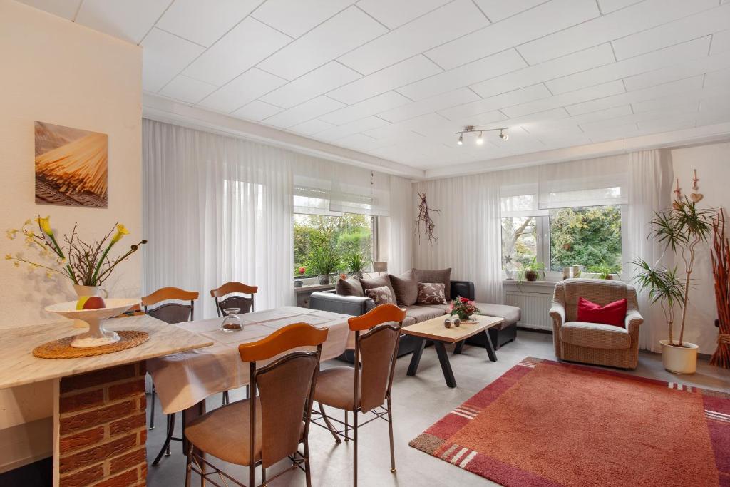 a living room with a table and chairs at Birkenhauer inkl Meine Card plus in Willingen