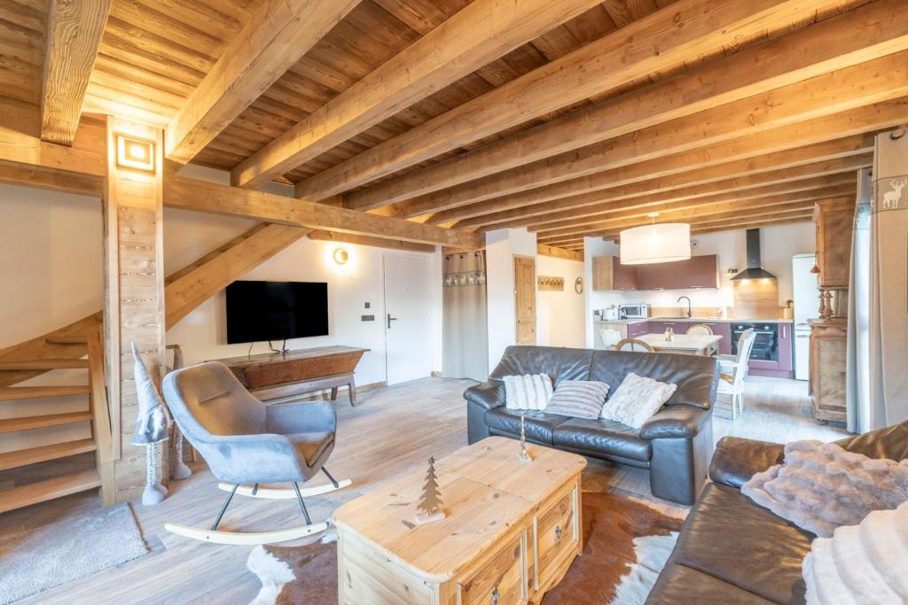 a living room with a couch and a table at Charlotte la Marmotte in Morillon