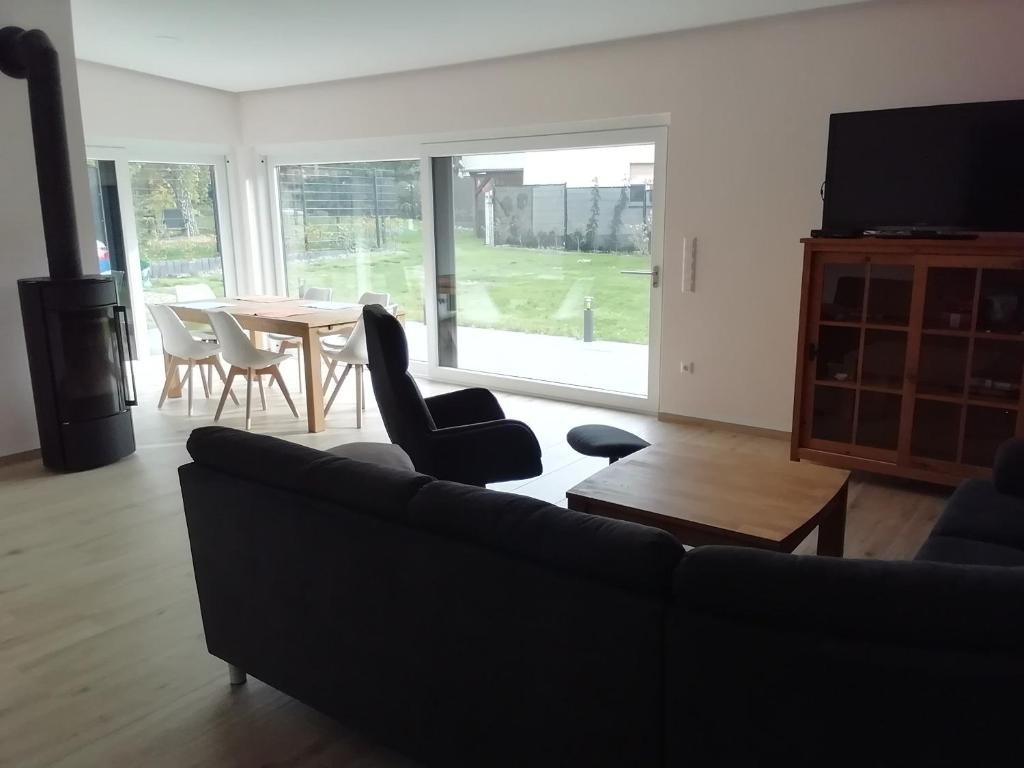 a living room with a couch and a table with chairs at Loewe Bad Frankenhausen in Bad Frankenhausen
