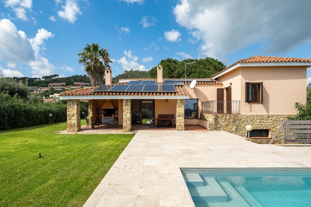 a villa with a swimming pool and a house at Villa Ulivi 10 in Is Molas 