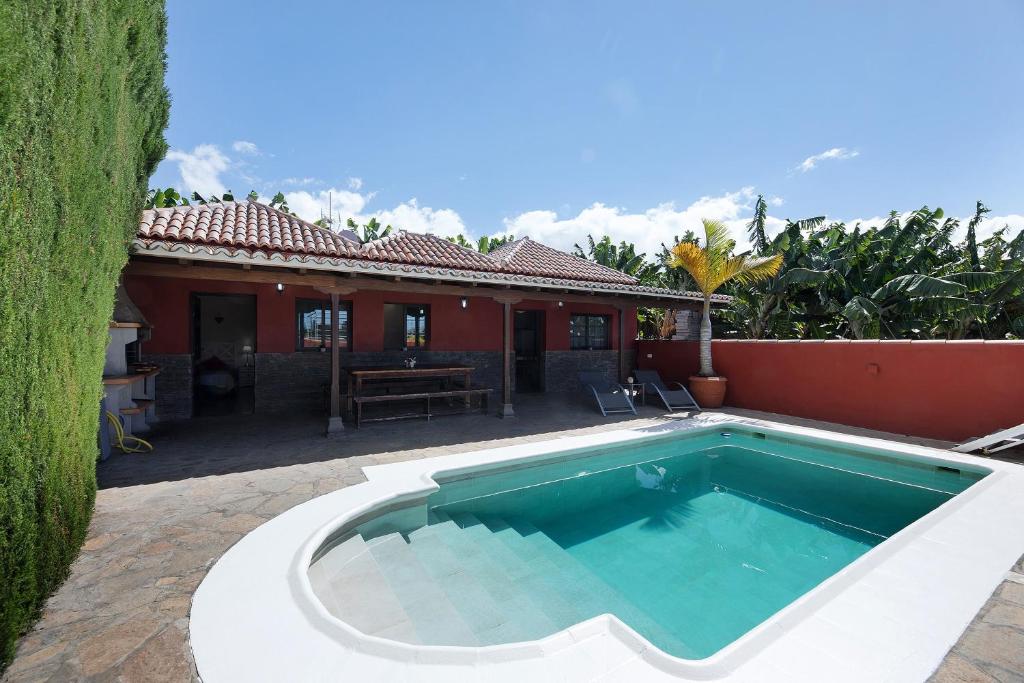 a swimming pool in front of a house at Casa La Flamenca in Tijarafe