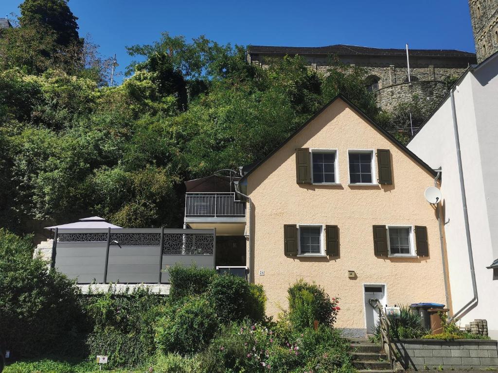 a house with a hill in the background at Haus Sonnenschein in Bad Bertrich