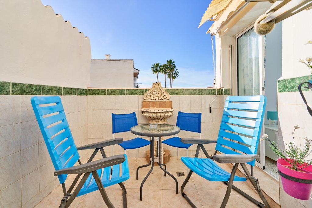 a patio with a table and chairs on a balcony at Butterfly apartment in Nerja