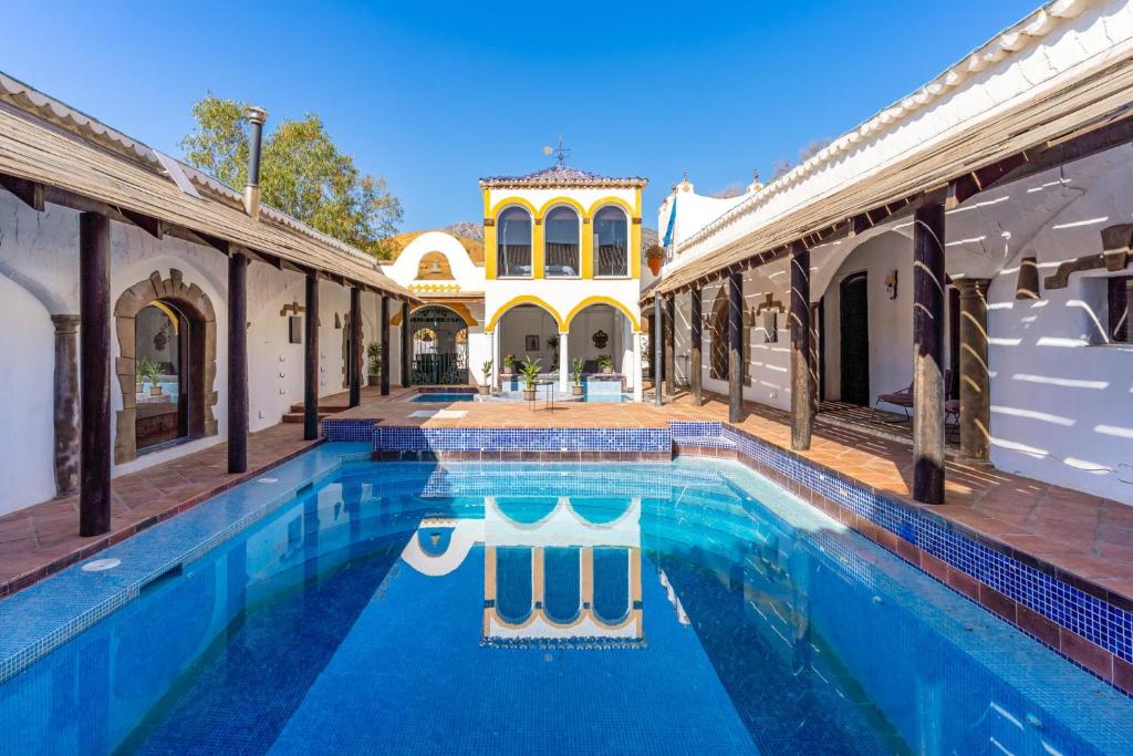 a large swimming pool in the courtyard of a house at Costa del Sol Retreat - 17 personas in Mijas