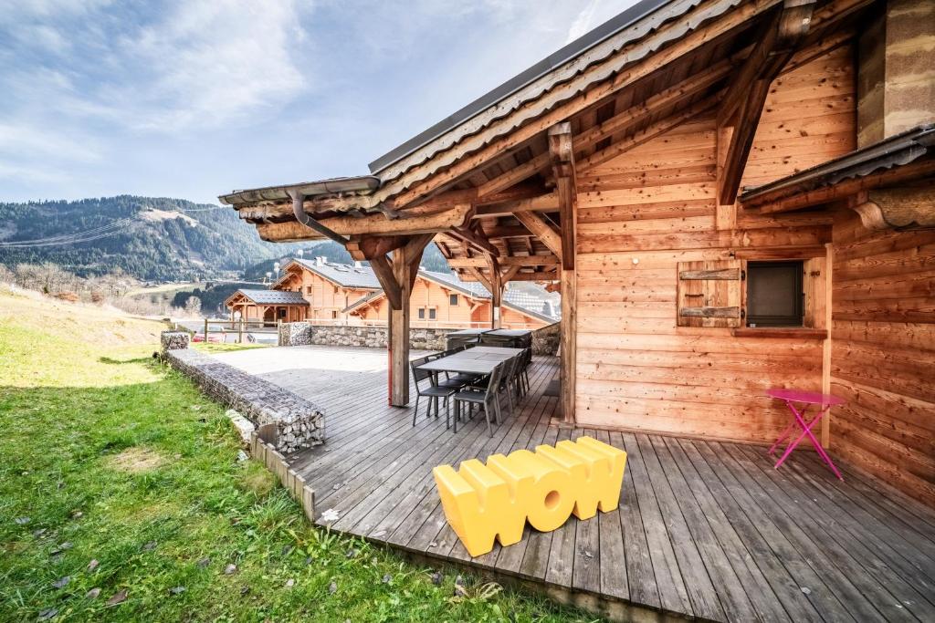 a wooden deck with a picnic table on a cabin at Chalet Heidi - Chatel in Châtel