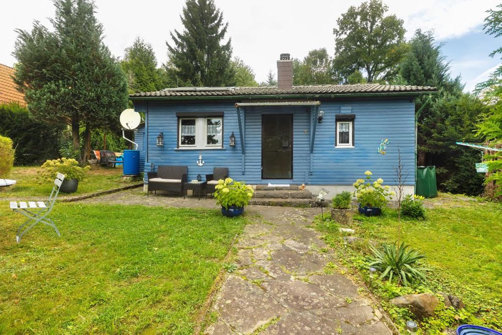 a blue tiny house in a yard at Haus am See in Gedern